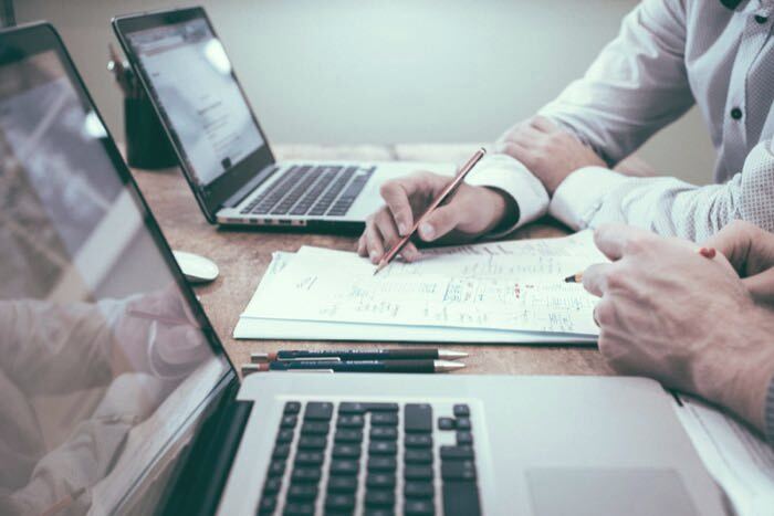 Working through a workflow plan together at a desk